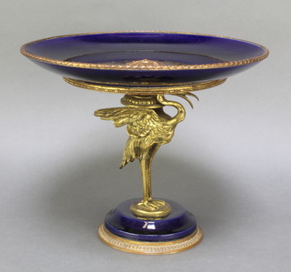 A 19th Century Limoges centre piece the dark blue ground with gilt metal mounts, the stem in the form of an exotic bird raised on a gilt metal mounted base with painted marks, 9" 