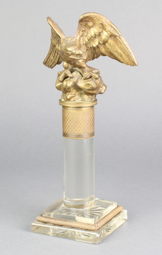 A 19th Century gilt metal and cut glass paperweight, the finial in the form of an eagle with outstretched wings, raised on a square base 8"h x 3"w  