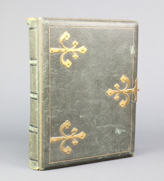 A Victorian leather bound photograph album with brass mounts (clasp missing) and some damage to the leather 