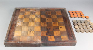 A 19th Century rectangular games compendium the top inlaid a chessboard, the interior inlaid a backgammon board, containing 14 circular turned plain wooden counters 1 1/2", 11 black and red painted counters 1 1/2" and 5 other associated counters  
