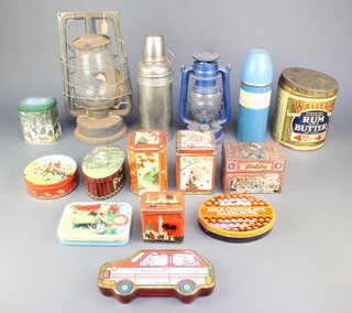 Two old hurricane lamps, a tin of Waller's Rum and Butter toffee and other tins etc 