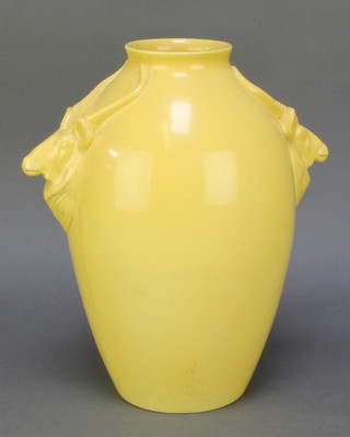 Ashtead Pottery, a yellow glazed pottery vase with antelope handles 11" 