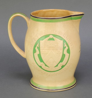 Ashtead Pottery, a tan glazed pottery jug to commemorate Clifton College founded 1862, a first edition strictly limited to  300 jugs being no. 44,  bearing the signatures of DP Percival and the artist Allan G Wyon 7 1/2" 