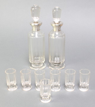 A pair of Continental cut glass spirit decanters with silver collars together with 7 tots 