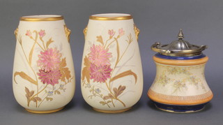 An Edwardian china biscuit barrel with plated lid and swing handle 7" and a pair of Edwardian blush porcelain vases with lion ring handles decorated with flowers 9" 