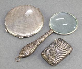 A Victorian repousse silver vesta Birmingham 1896, a silver compact and magnifying glass