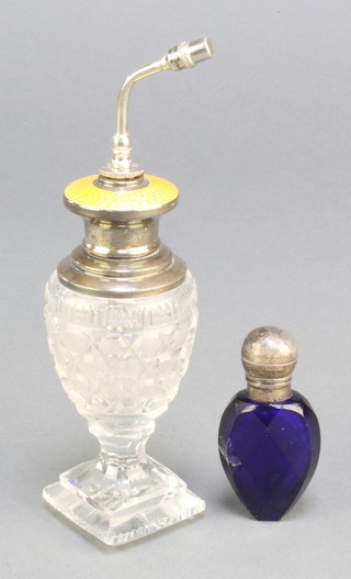 A Sterling silver and yellow guilloche atomiser and a Victorian silver mounted blue glass scent 