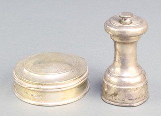A circular silver trinket box Birmingham 1946 and a silver pepper mill Birmingham 1949 