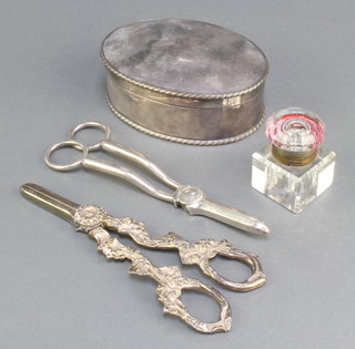 An oval silver plated box 4 1/2", 2 pairs of grape scissors and an ink well 