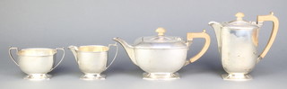 A silver 4 piece tea and coffee set with fruit wood handles, Sheffield 1941/42 1686 grams 