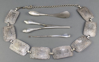 A silver mounted glove stretcher and 2 other implements and a white metal belt
