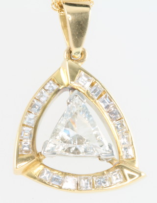 A yellow gold pendant set with a triangular cut diamond and princess cut diamonds on an 18ct yellow gold chain 