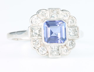 An 18ct white gold tanzanite and diamond ring, the square cut tanzanite approx. 1.15ct surrounded by baguette and brilliant cut diamonds, approx. 0.85ct, size P