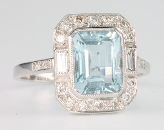 An 18ct white gold Art Deco style aquamarine and diamond ring, the centre stone approx. 2.2ct surrounded by brilliant and baguette cut diamonds approx 0.4ct, size P 