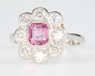 An platinum pink sapphire and diamond ring, the centre stone approx 1.05ct surrounded by brilliant cut diamonds approx. 1.2ct, size O 1/2