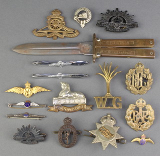 A quantity of WWII and later cap badges and a Trench Art knife