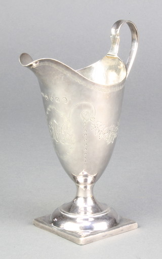 A George IV silver helmet shaped cream jug with chased floral swags and monogram, London 1829 98 grams