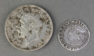 A Queen Elizabeth I reproduction silver sixpence "1595" and a crown 1935 