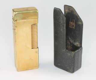 A gentleman's gilt engine turned Dunhill cigarette lighter in a Dunhill leather pocket