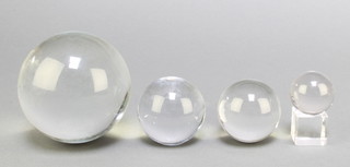 A glass ball 4", 3 others and a clear glass stand