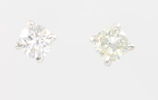 A pair of 18ct white gold single stone diamond ear studs, each approx 0.34 and 0.43ct 
