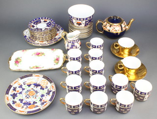 A Davenport style Imari pattern part tea set comprising 12 tea cups, 12 saucers, 12 tea plates, 2 serving plates, a milk jug, slop bowl, similar pot and minor china 