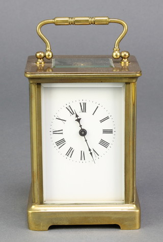 A 19th Century French 8 day carriage timepiece with enamelled dial and Roman numerals contained in a gilt metal case 4" x 3" x 2 1/2" 
