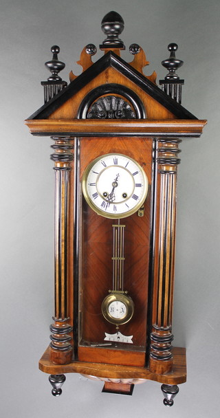 A striking Vienna style regulator with 5" enamelled dial and Roman numerals with grid iron pendulum contained in a walnut case 