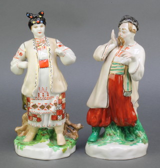 A pair of mid 20th Century figures of a lady and gentleman on rustic bases 10" 