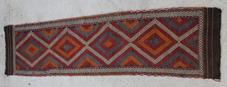 A blue and red ground Meshwani runner with 5 diamonds to the centre 97" x 26" 