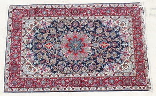 A blue ground and floral patterned Persian rug with central medallion 68" x 44 1/2", signed 