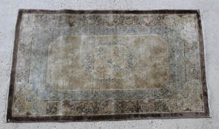A Chinese silk brown ground rug of sculpted design 61" x 36"