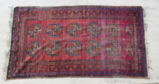 A red and blue Afghan rug with medallions to the centre