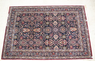 A blue and red ground Indian carpet with floral design 107" x 72" 