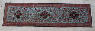 A turquoise and red ground floral patterned Persian Saraigh runner 119" x 32" 