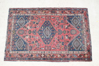 A Persian blue and red ground Malayer rug with central medallion 77" x 50"