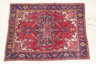 A red and blue ground Persian Heriz rug 73" x 57"