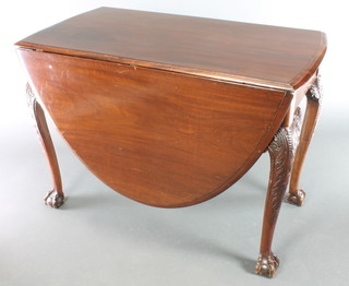 A Georgian oval drop flap dining table, raised on carved cabriole ball and claw supports 30"h x 41 1/2"w x 22" when closed by 64" when fully extended 