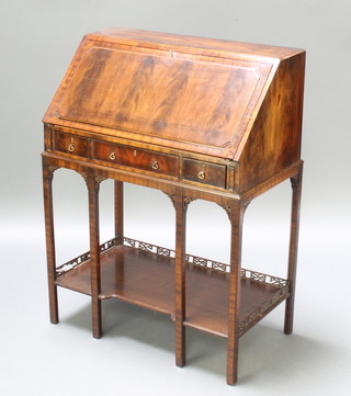 A Chippendale style mahogany bureau with fret decoration, the fall front revealing a stepped interior, the base fitted 1 long and 2 short drawers, raised on 6 chamfered supports with undertier 39 1/2"h x 29"w x 17"d 

