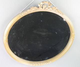 An oval bevelled plate wall mirror contained in a gilt reeded frame surmounted by a garland 18" x 21 1/2" together with 1 other circular gilt framed mirror 21" x 18" 