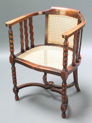 A Victorian oak tub back chair with woven cane seat and back and X framed stretcher, raised on bobbin turned supports