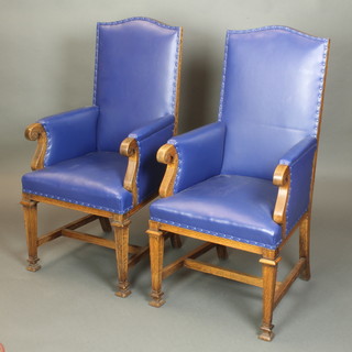 A pair of Victorian Arts and Crafts oak show frame armchairs upholstered in blue material, raised on square tapering supports with shaped framed stretcher (1 has slight chip to the back right hand leg) 