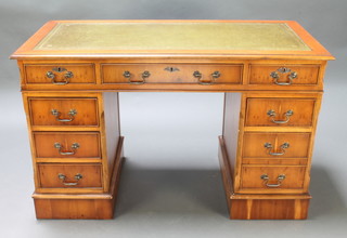 A Georgian style yew kneehole pedestal desk with inset green writing surface, fitted 1 long and 8 short drawers 30"h x 48 1/2"w x 24"d 