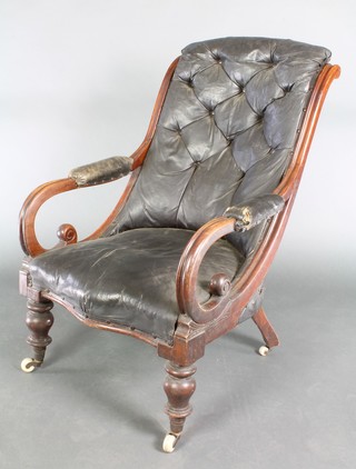 A Victorian mahogany open arm chair, upholstered in black rexine, raised on turned supports  