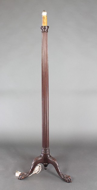 An Edwardian fluted mahogany standard lamp raised on a tripod base with egg and claw feet 57"h 