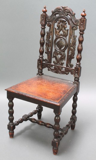 A Victorian carved oak and ebonised Carolean style hall chair with pierced slat back and solid seat, raised on turned supports with H framed stretcher 