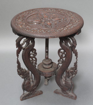 A 19th Century Anglo Indian circular carved hardwood occasional table, the top carved peacocks, raised on 3 carved and pierced supports decorated dragons 21"h x 20" diam. 