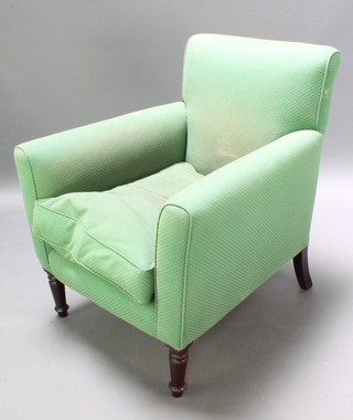 A 19th Century library chair upholstered in green material, raised on turned supports 