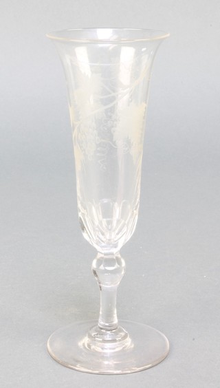 A faceted champagne glass with vinous decoration and knopped stem