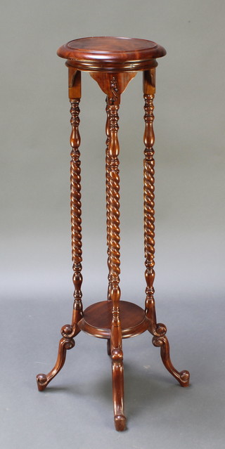 A Victorian style circular 2 tier mahogany jardiniere stand on spiral turned supports with under tier 39"h x 11" diam.  